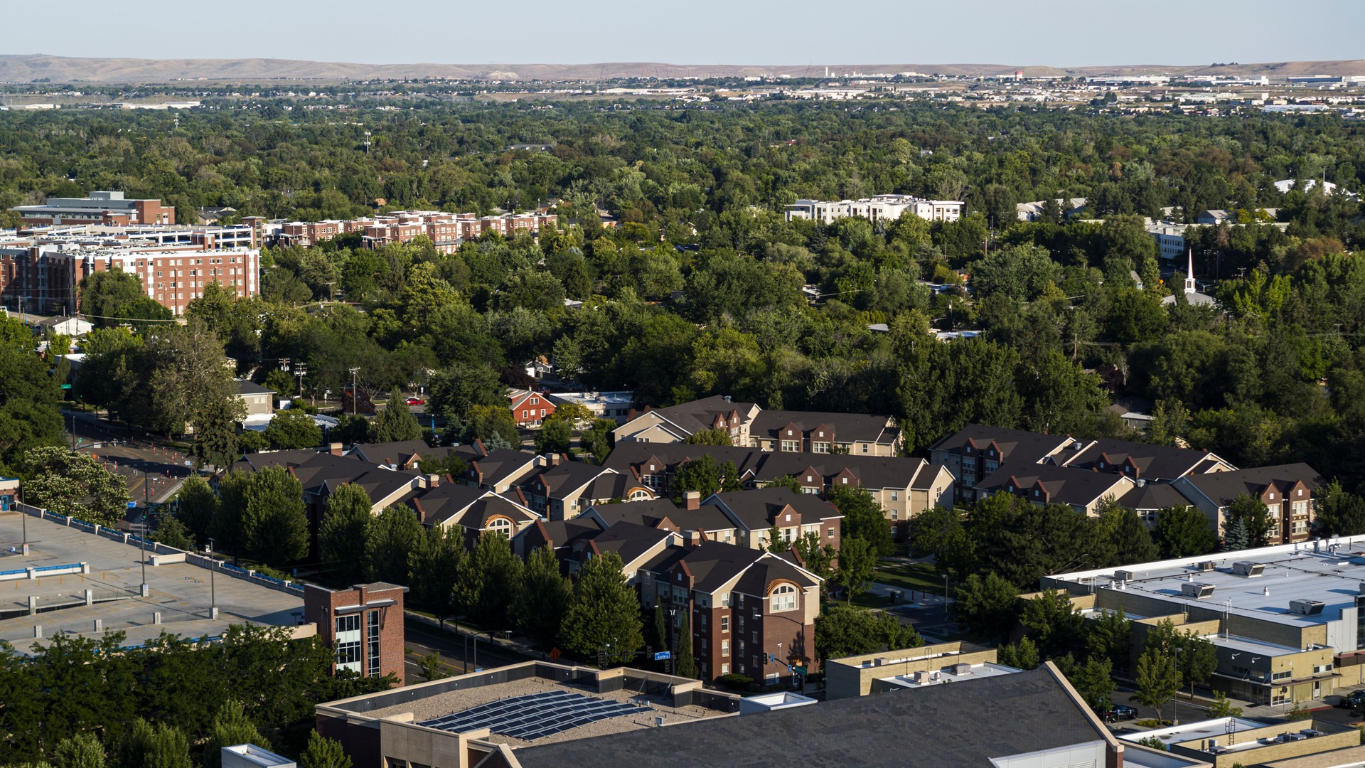 Residential neighborhood surrounded by trees. Bird's eye view of Boise, Idaho urban landscape.